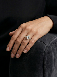 Person wearing a ring on a dark background